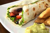 Mexican tortilla wraps with chicken, beans, tomato, lettuce