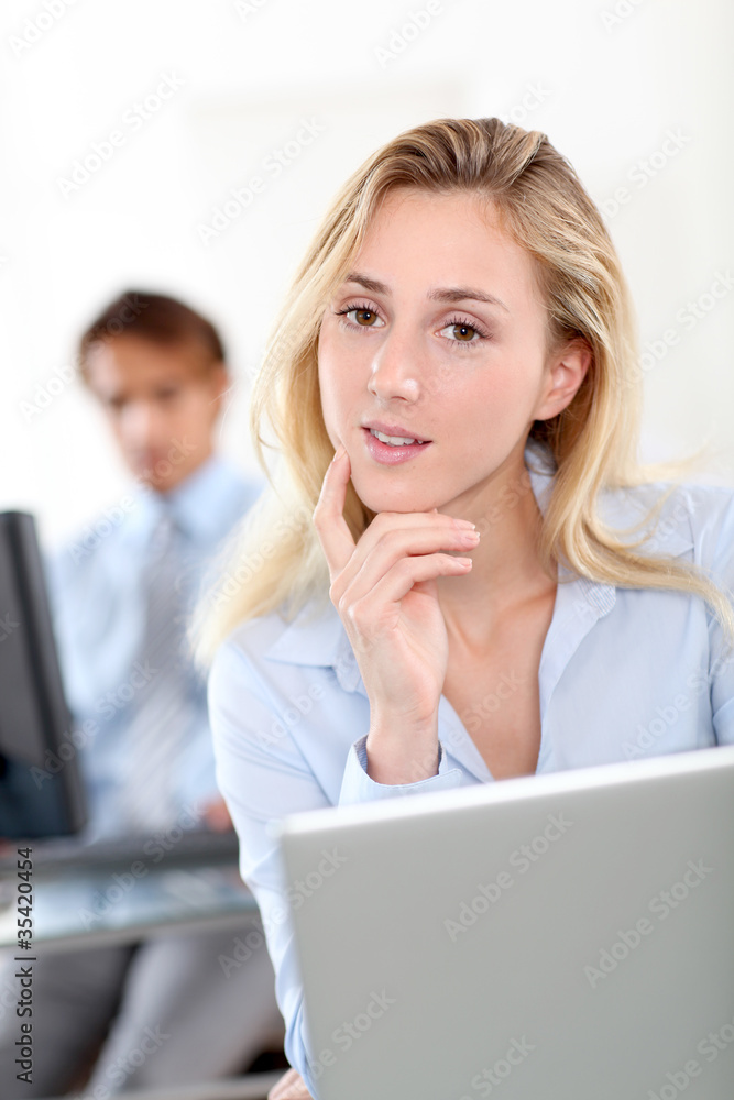 Beautiful woman in office working on laptop computer Beautiful woman in office working on laptop computer