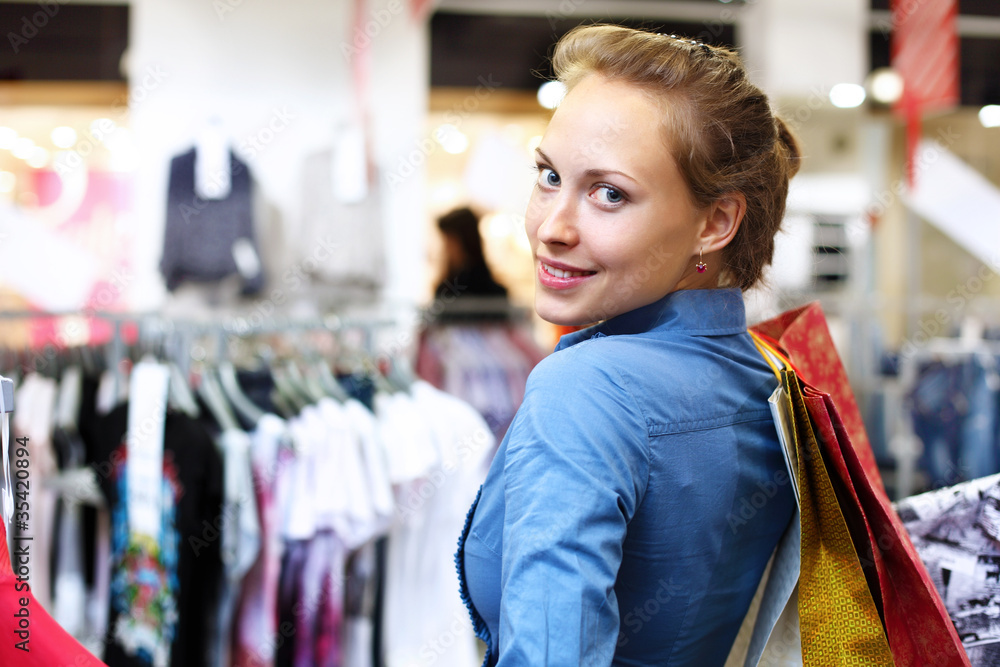 Woman in a shop buying clothes
