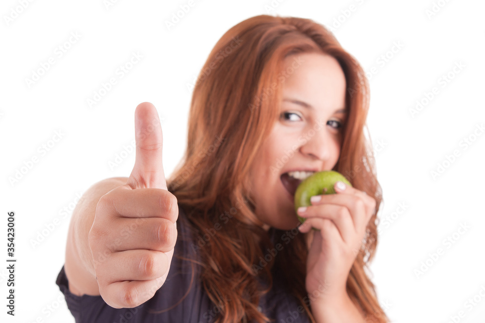 Young woman with green apple and showing thumb up Young woman with green apple and showing thumb up