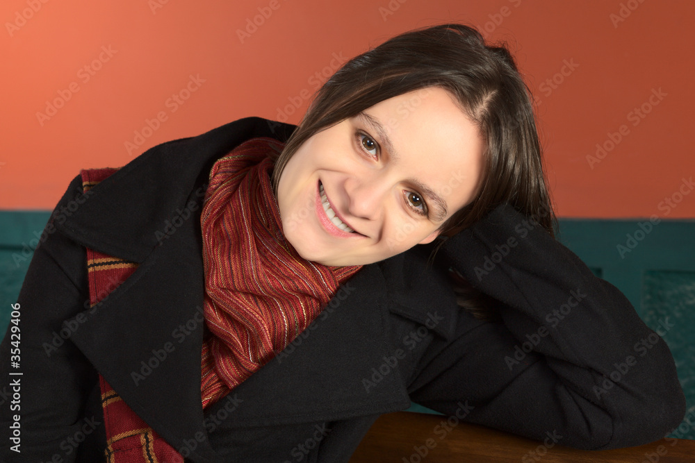 Smiling young Caucasian woman sitting on a bench Smiling young Caucasian woman sitting on a bench
