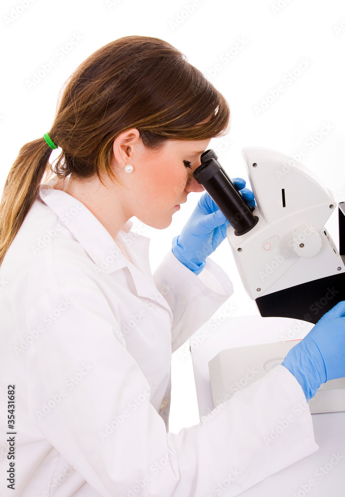 Portrait of medical student looking through microscope in labora