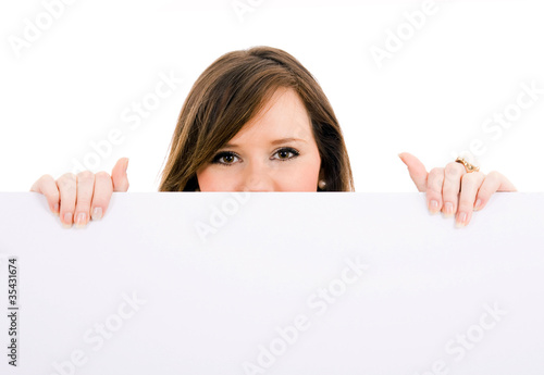 Picture of beautiful brunet woman holding a blank billboard