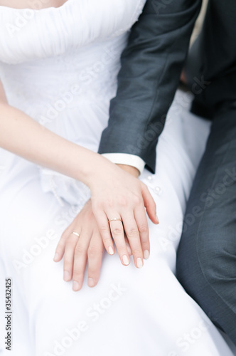 Bride and groom holding each others hands