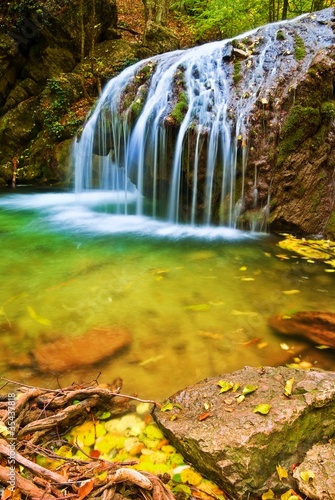 water cascades on a autumn river