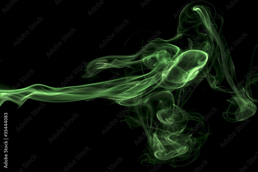 Obraz premium Abstract green colored smoke, black background.
