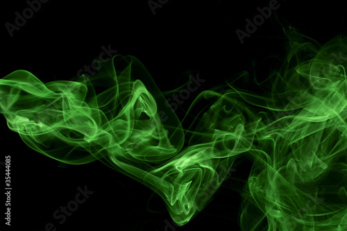 Abstract green colored smoke, black background.