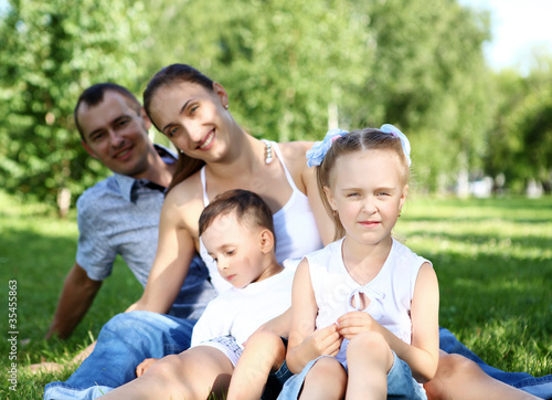 Family with two children in the summer park