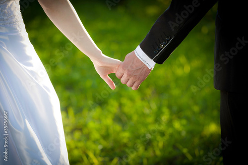 Young married couple holding hands