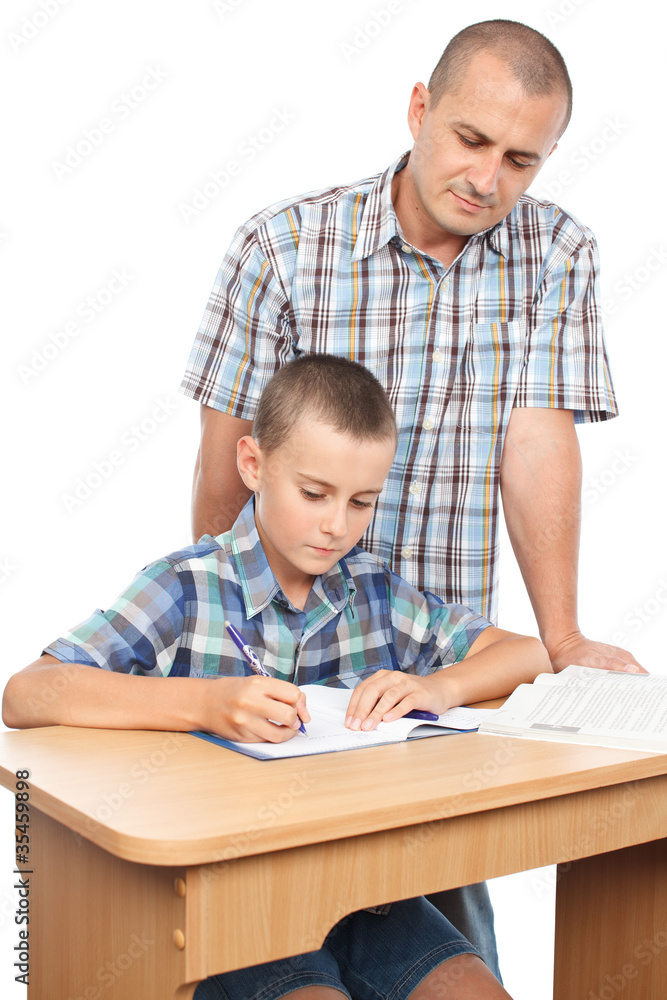 Father verifying son's homework Father verifying son's homework