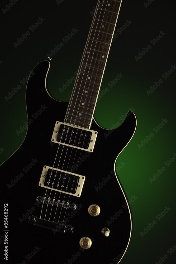 Black Electric Guitar on Green