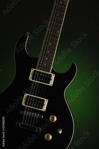 Black Electric Guitar on Green