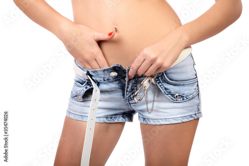 Torso of the girl removing shorts isolated