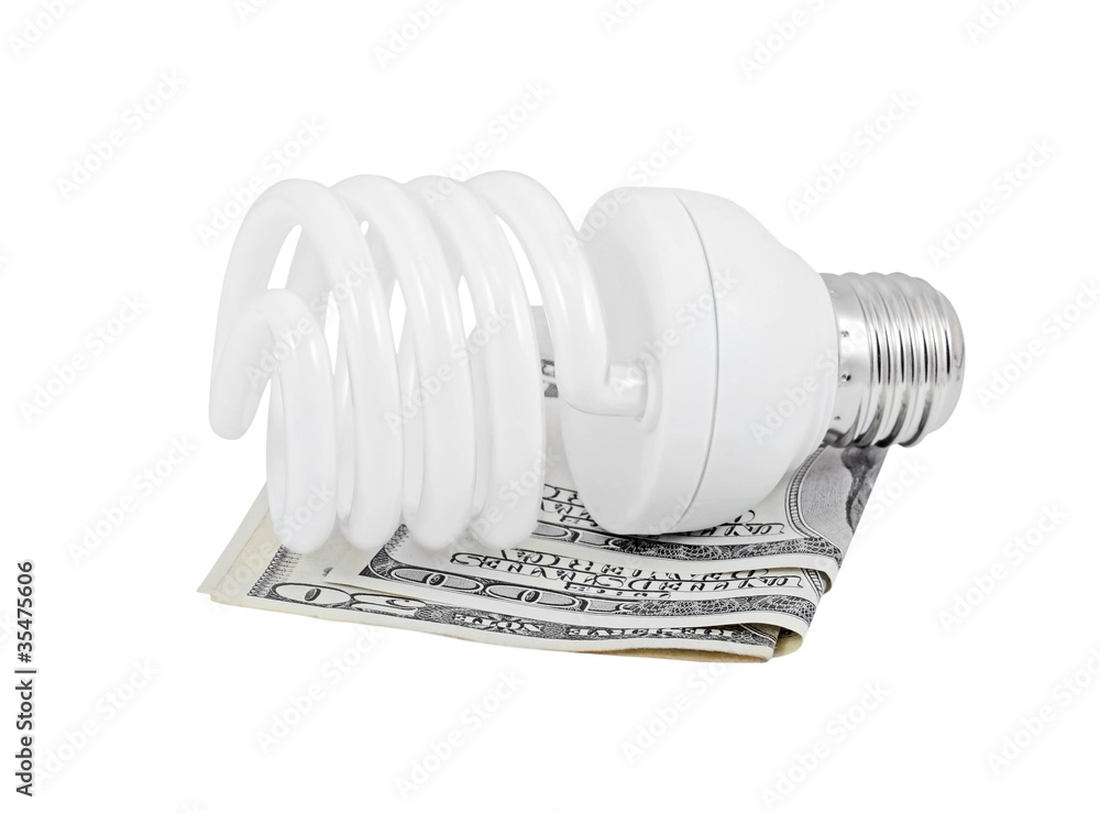 Energy saving light bulb and money, isolated on a white Energy saving light bulb and money, isolated on a white