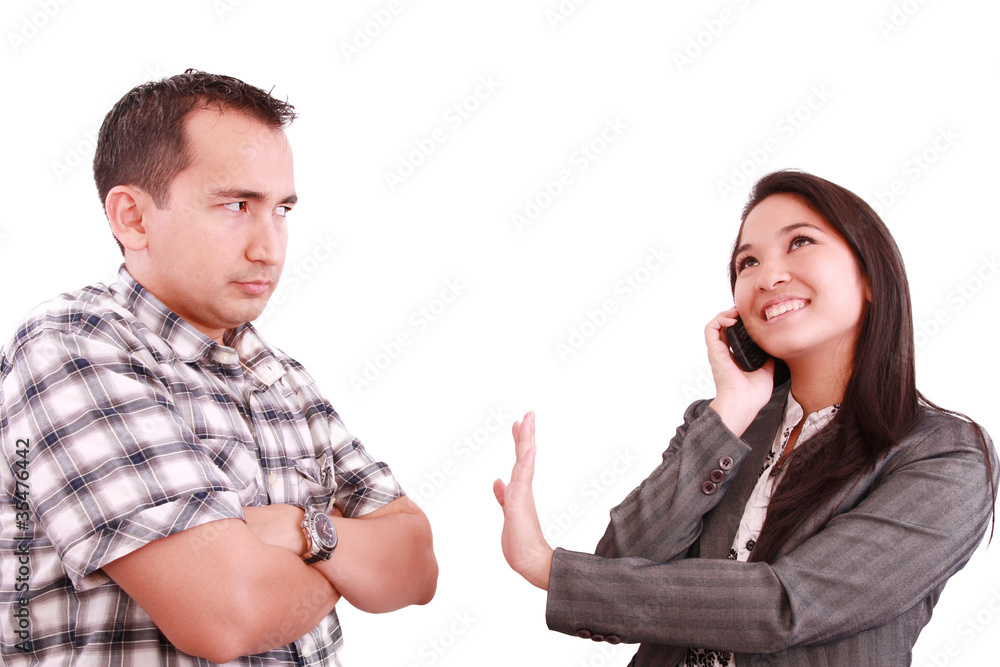 smiling businesswoman on the phone signaling his couple to hold smiling businesswoman on the phone signaling his couple to hold