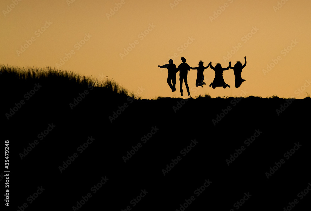 silhouette of people jumping on dune silhouette of people jumping on dune