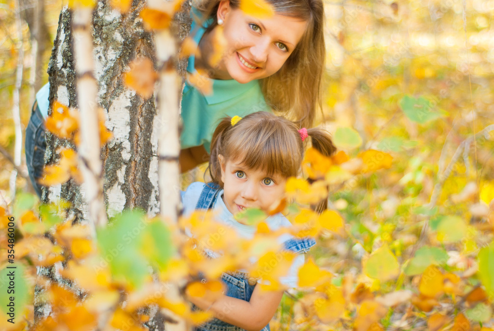 Young family in autumn forest Young family in autumn forest