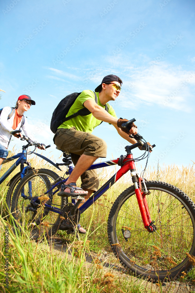 cyclists on meadow