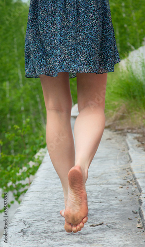 A young woman goes barefoot