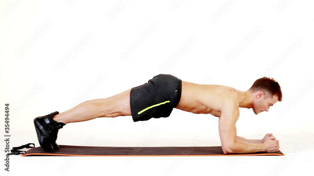 Handsome muscular man exercising on white background Handsome muscular man exercising on white background