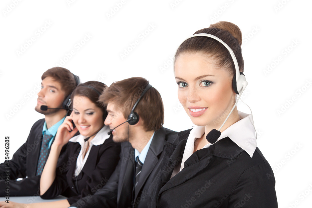 Smiling young businesswoman and colleagues in a call center Smiling young businesswoman and colleagues in a call center