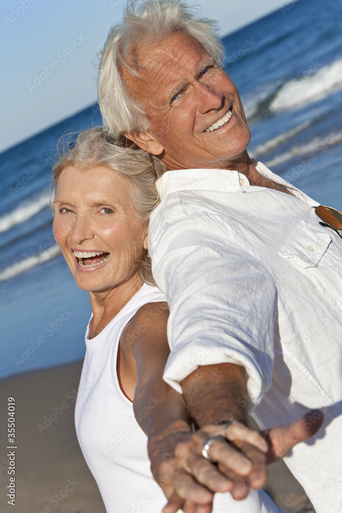 Happy Senior Couple Back to Back Holding Hands on Beach Happy Senior Couple Back to Back Holding Hands on Beach
