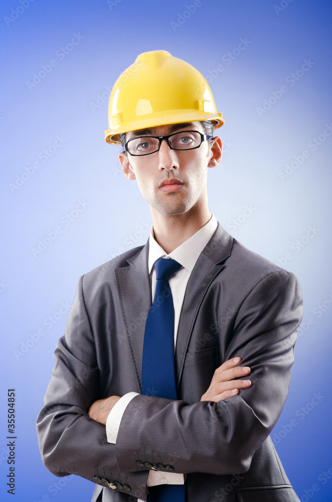 Young architect with drawings and hardhat Young architect with drawings and hardhat
