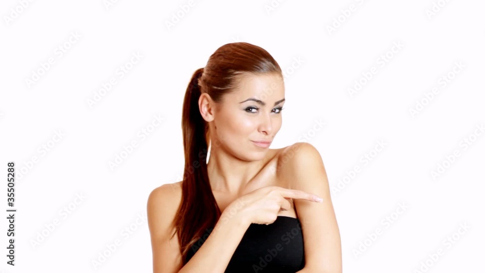 Smiling and sexy brunette pointing at copy space Smiling and sexy brunette pointing at copy space