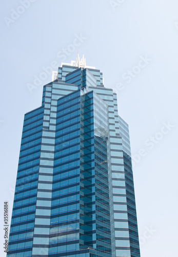 Dark and Light Blue Glass Office Tower Rising into Sky