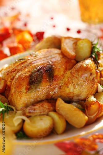 Whole roasted chicken with potatoes and apples