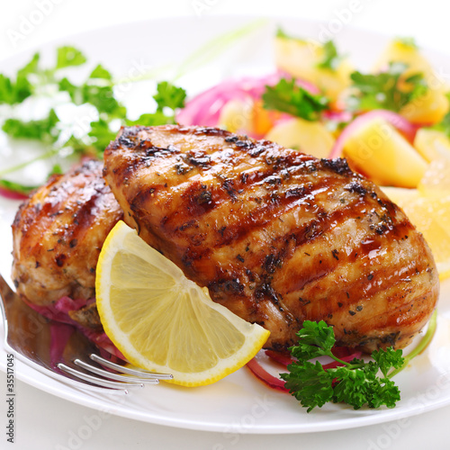 Grilled chicken breast on white plate