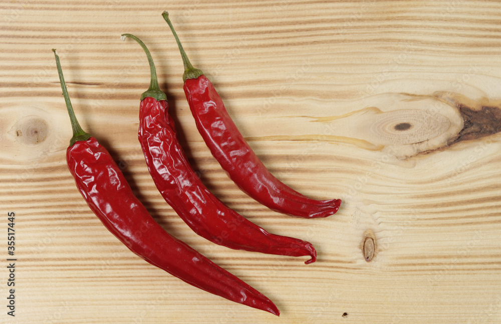 Red chili peppers on wooden table