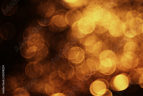 blurred bokeh blurs of orange light on dark