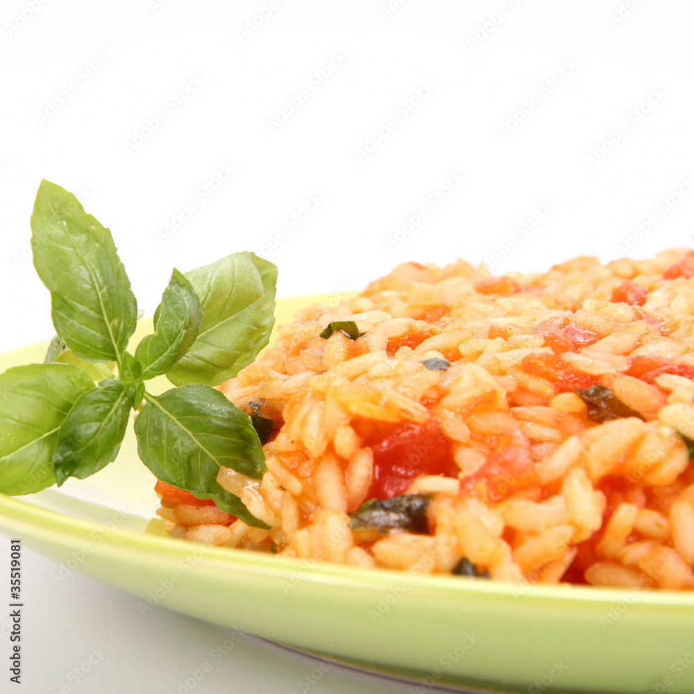 Risotto with tomatoes decorated with basil Risotto with tomatoes decorated with basil