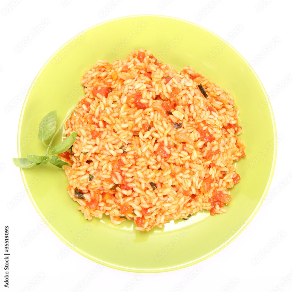 Risotto with tomatoes decorated with basil Risotto with tomatoes decorated with basil