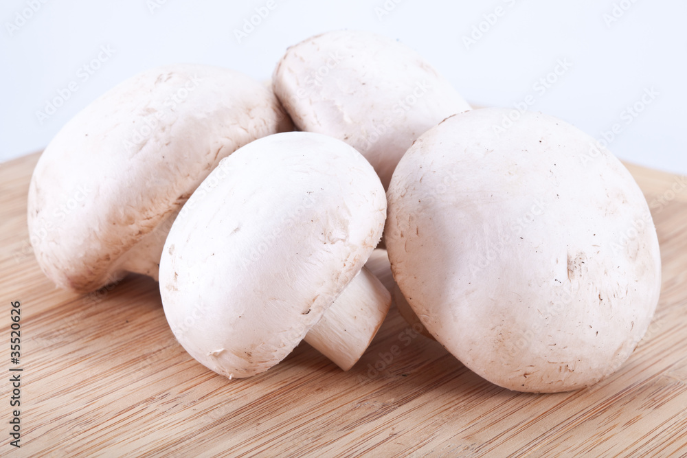 Field mushrooms on a wooden board