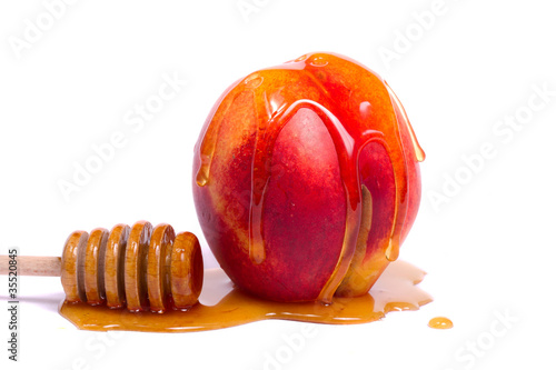 peach with honey dipper