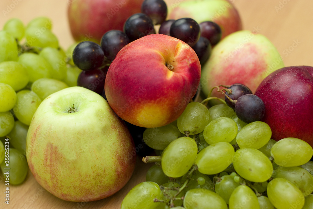 Fresh fruits, apples, grapes and peaches on the table Fresh fruits, apples, grapes and peaches on the table