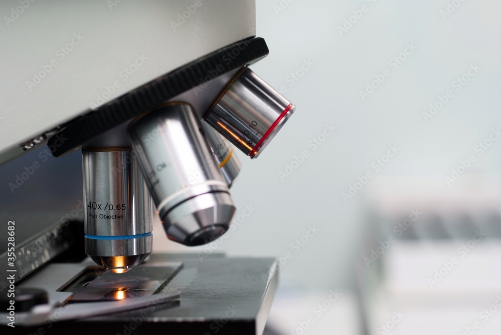 Microscope in lab on gray