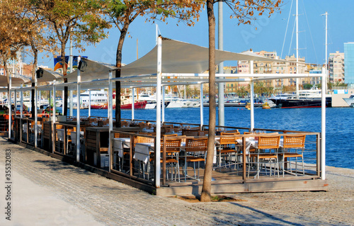 restaurant on a terrace on quay in port of barcelona, spain, cat