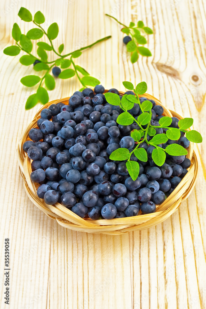 Blueberries in a wicker tray on a blackboard Blueberries in a wicker tray on a blackboard