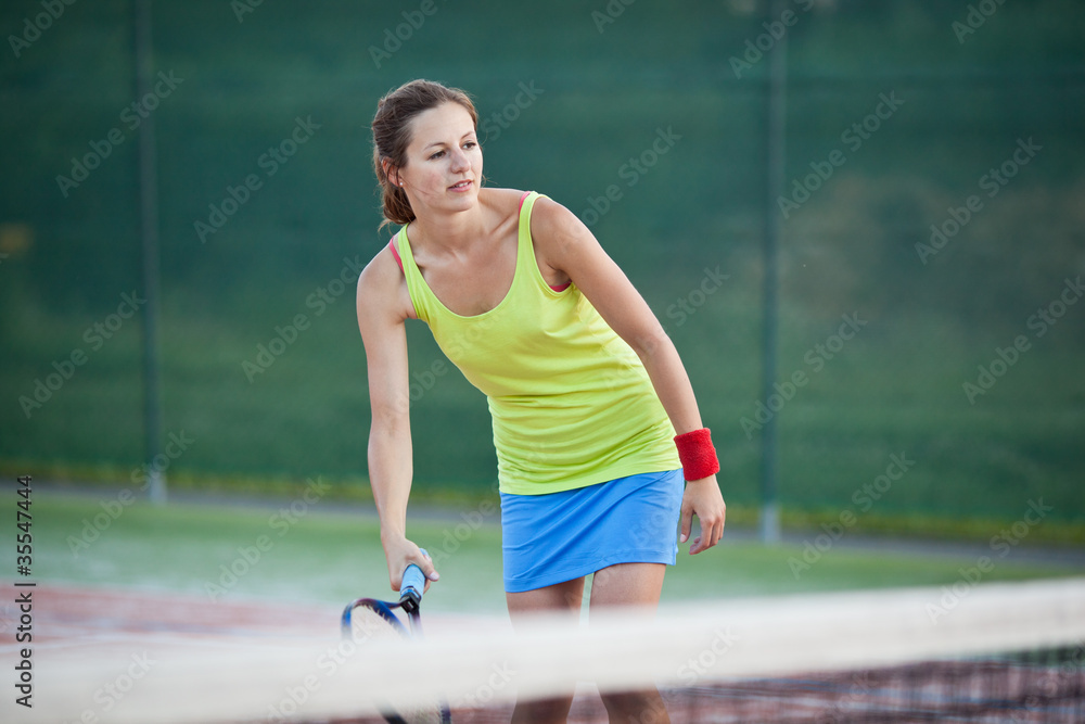 pretty, young female tennis player on the tennis court