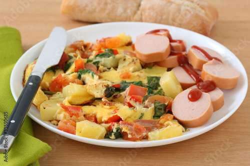 omelet with potato and cut sausages