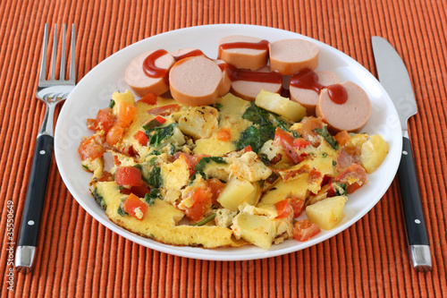 omelet with potato and cut sausages