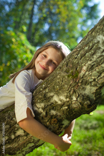 girl lying on a tree