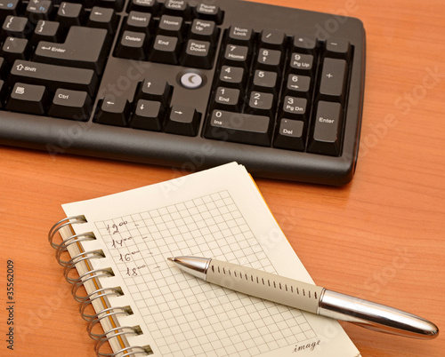 blank notebook on black keyboard