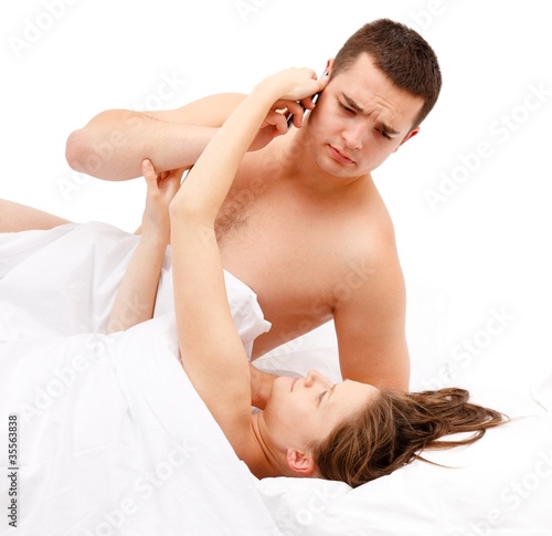 Laying woman taking phone from man