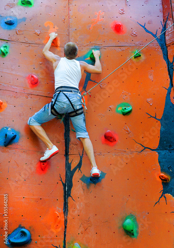 man climbing on a climbing wall