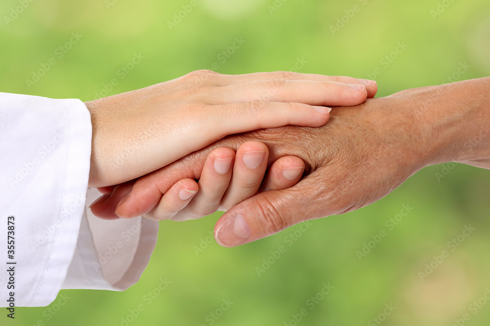 Woman hand helping senior in nature