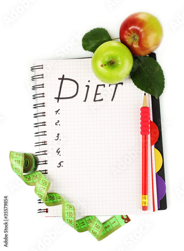 Planning of a diet. Notebook, pencil and fresh apples isolated